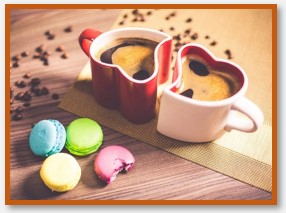 Coffee beverage with colorful cookie sweets.