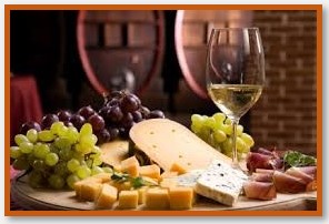 Wine beverage with grapes, bread and cheese