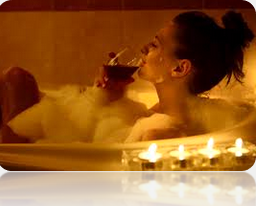 Woman in a candlelit bubble bath. 